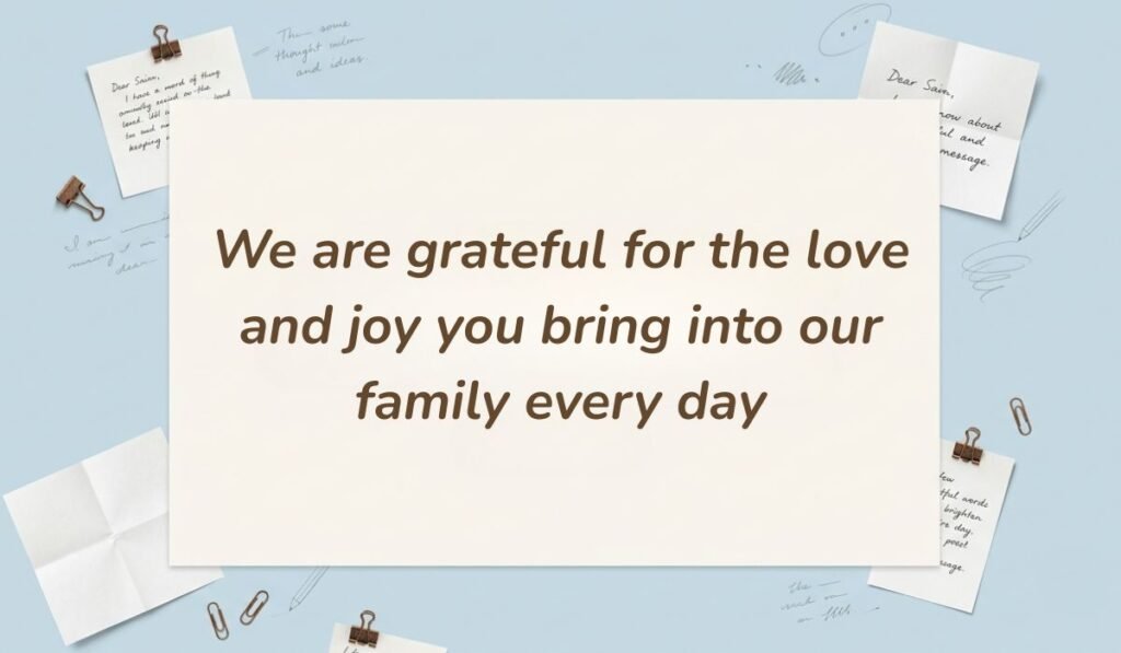 Light blue desk stationery setup with binder clips presenting birthday wishes for daughter in law reading "We are grateful for the love and joy you bring into our family every day"