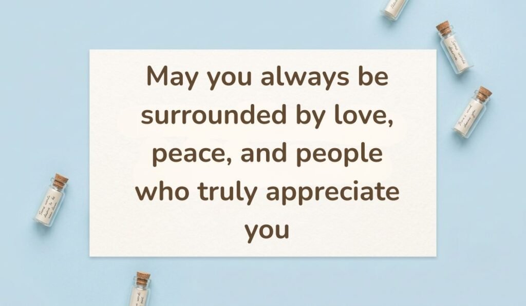 Clean blue background decorated with small glass wish bottles containing miniature rolled scrolls, highlighting a warm happy new month message for sister in law: "May you always be surrounded by love, peace, and people who truly appreciate you."