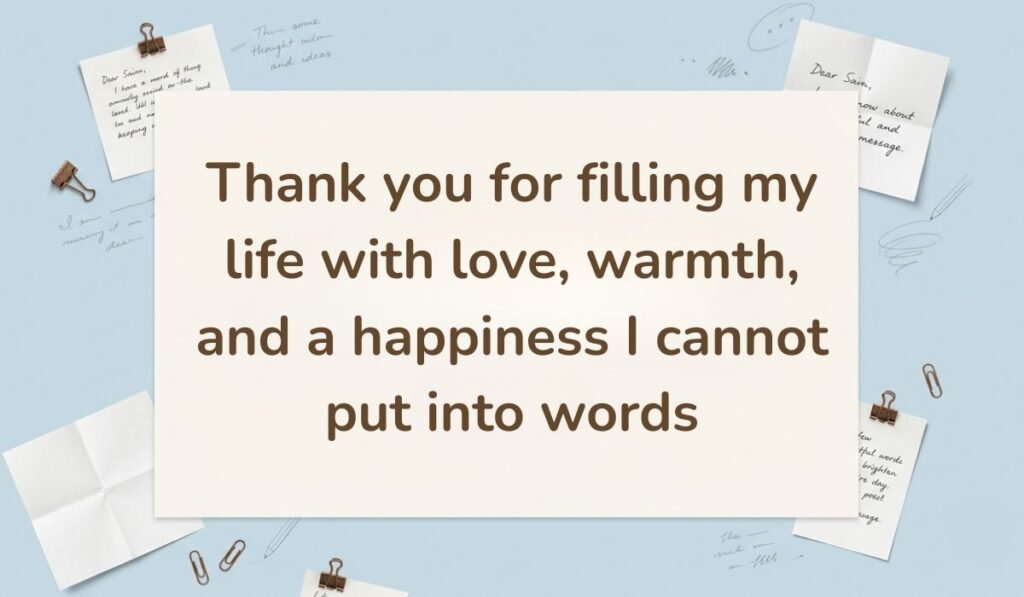Light blue background accented with paper clips and handwritten sticky notes, displaying a heartfelt happy new month message to my wife: "Thank you for filling my life with love, warmth, and a happiness I cannot put into words".