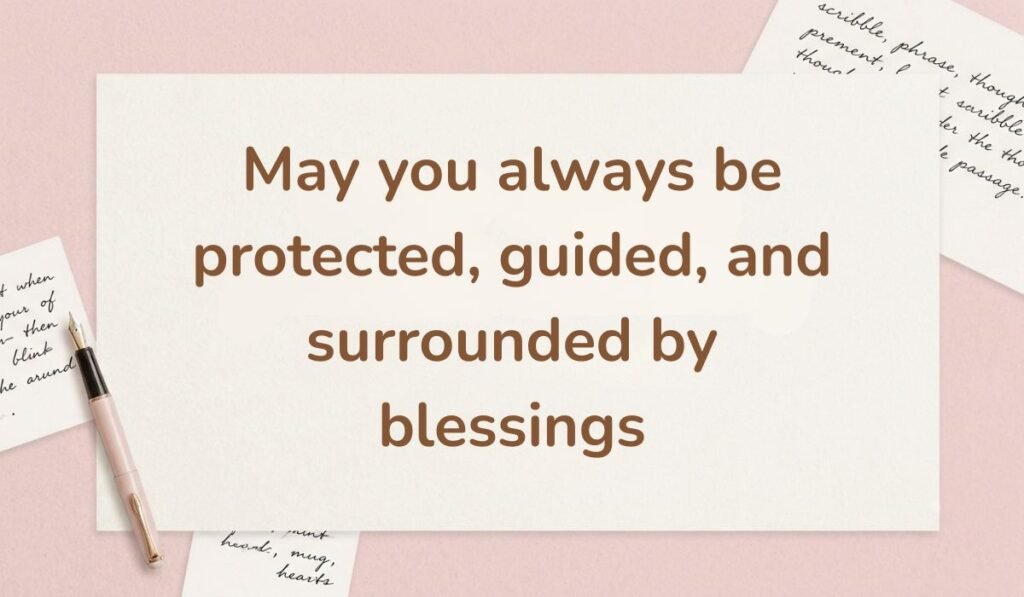 Pink workspace background with a fountain pen and handwritten notes, featuring a warm happy new month message to my wife: "May you always be protected, guided, and surrounded by blessings".