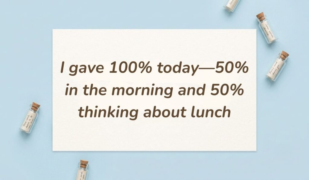 Light blue flat lay with mini glass message bottles showing funny quotes for the day at work reading, "I gave 100% today—50% in the morning and 50% thinking about lunch"