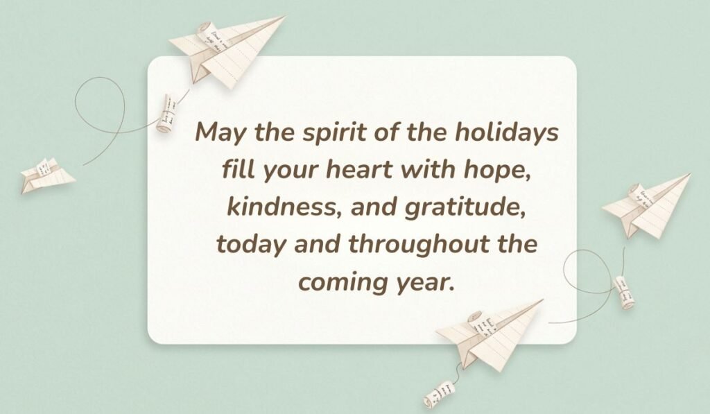 Soft mint green card setting with folded paper airplanes featuring greeting card messages for holidays reading, "May the spirit of the holidays fill your heart with hope, kindness, and gratitude, today and throughout the coming year."