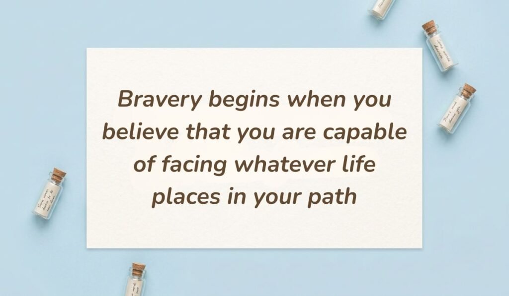 Light blue surface surrounded by mini corked glass message bottles showing quotes for bravery and courage stating, "Bravery begins when you believe that you are capable of facing whatever life places in your path."