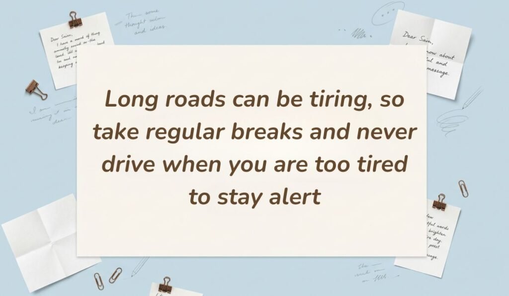 Light blue workspace scene with paperclips and handwritten notes presenting safety messages for truck drivers stating, "Long roads can be tiring, so take regular breaks and never drive when you are too tired to stay alert"
