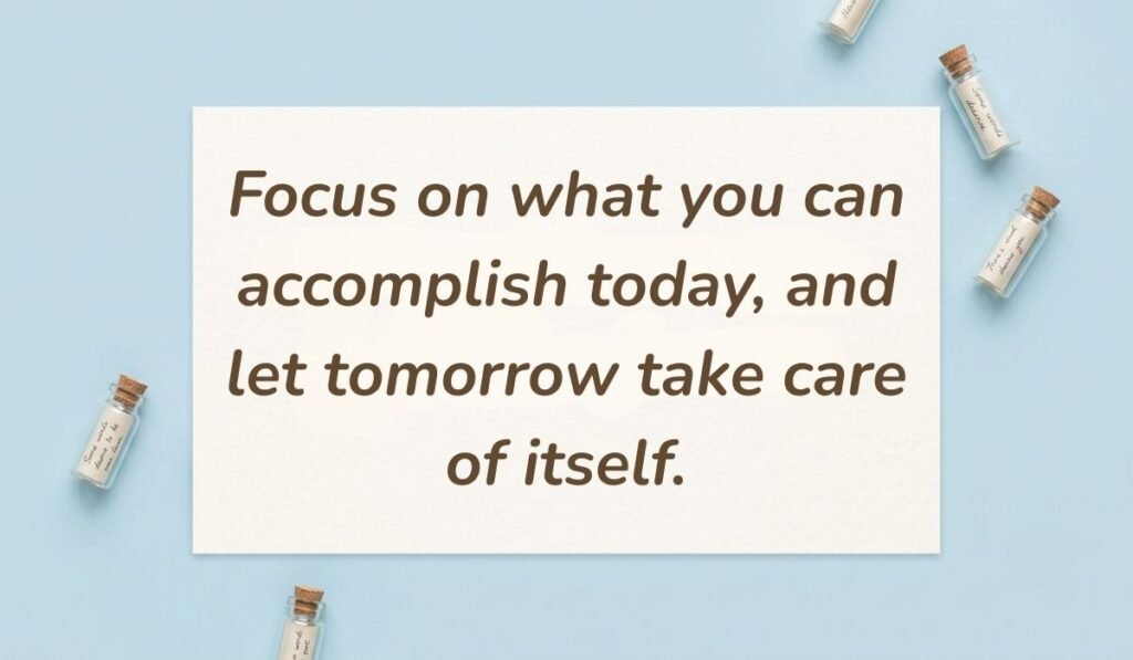 Light blue flat lay with mini glass message bottles showing tuesday motivational quotes for work reading, "Focus on what you can accomplish today, and let tomorrow take care of itself."