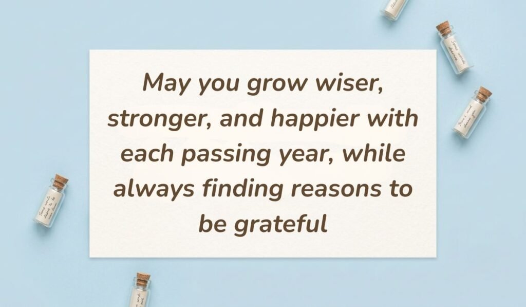 Light blue surface decorated with tiny glass message bottles featuring happy birthday blessings reading, "May you grow wiser, stronger, and happier with each passing year, while always finding reasons to be grateful"