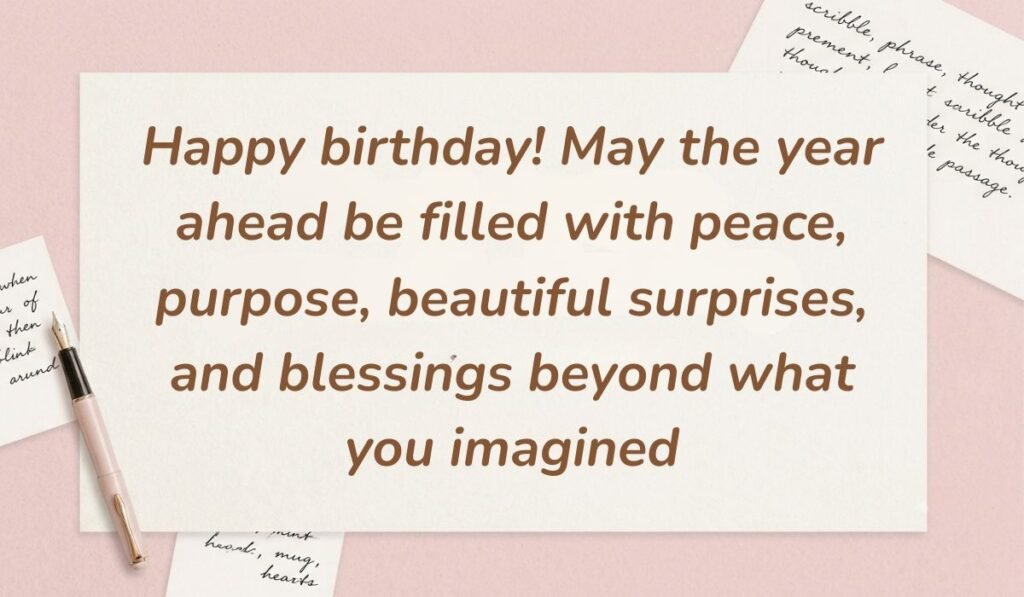 Soft pink background arranged with handwritten note cards and a pen displaying happy birthday blessings stating, "Happy birthday! May the year ahead be filled with peace, purpose, beautiful surprises, and blessings beyond what you imagined"