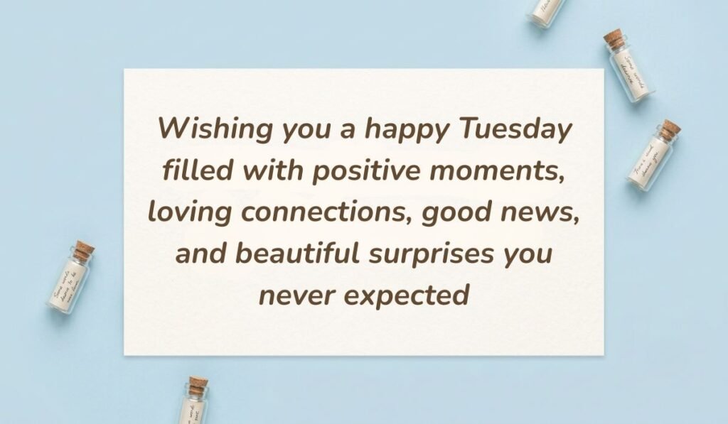 Light sky blue surface arranged with miniature glass message bottles featuring happy tuesday blessings reading, "Wishing you a happy Tuesday filled with positive moments, loving connections, good news, and beautiful surprises you never expected"