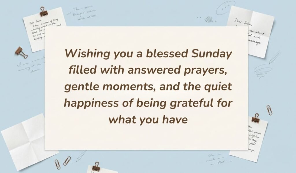 Light blue workspace setting decorated with pinned handwritten notes and paperclips showcasing sunday blessings stating, "Wishing you a blessed Sunday filled with answered prayers, gentle moments, and the quiet happiness of being grateful for what you have"